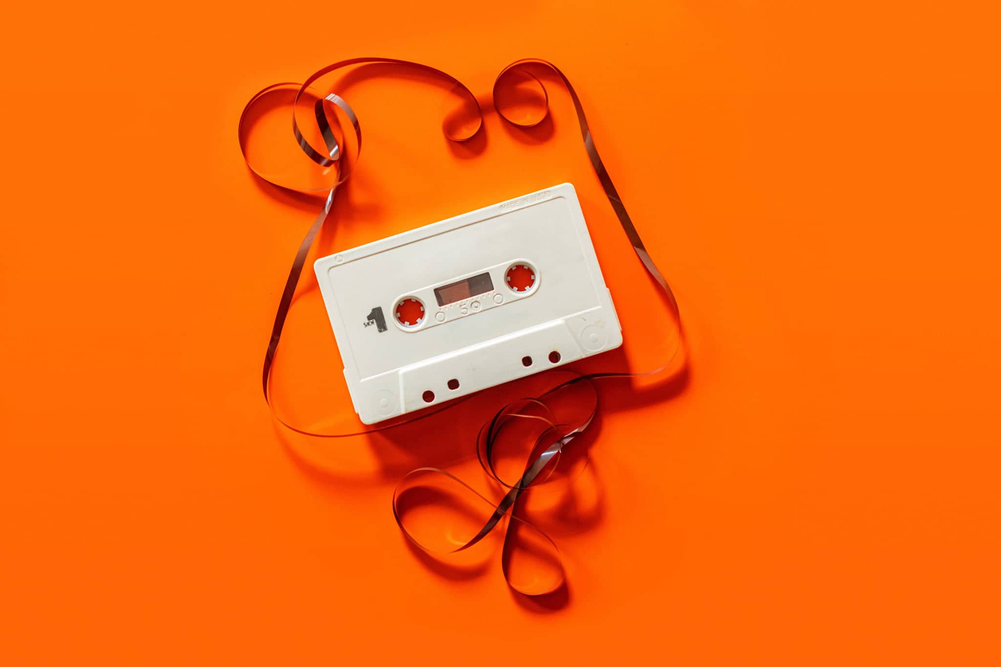 cassette tape being duplicated on orange background