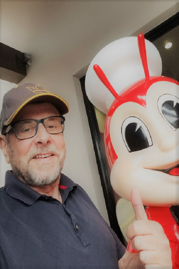 photo of our founder, Alan, visiting one of our clients, Jollibee and as he is a joking kind of guy, he had to have a portrait of he and their mascot