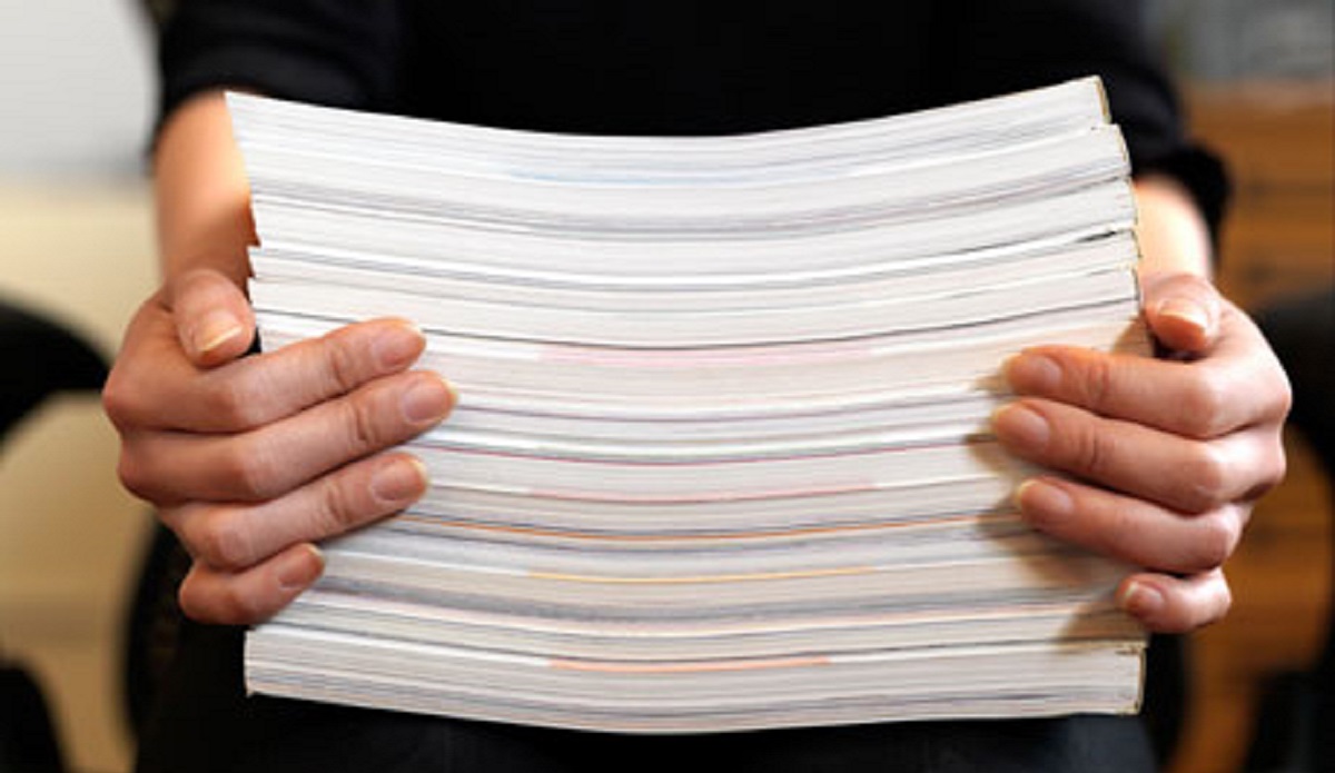 doctor holding a stack of medical records